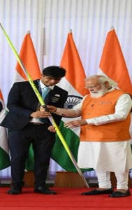 PM Modi taking autograph by Neeraj Chopra on a javelin