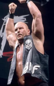 Steve Austin gestures to the crowd ahead of a WWE match 